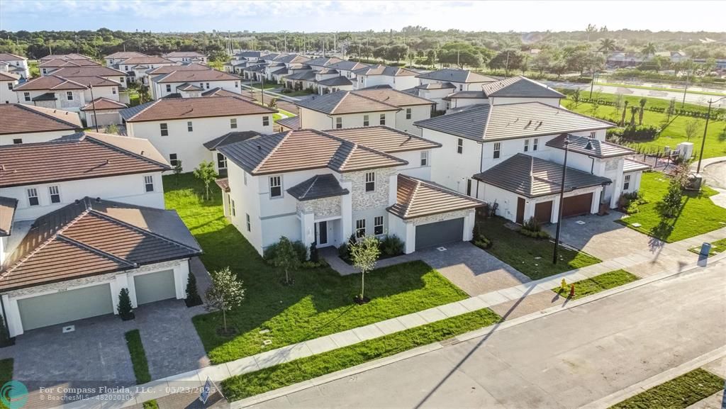 12328 Southwest 43rd Street Davie, FL 33330 - Photo 64 of 96 an aerial view of multiple houses with a yard