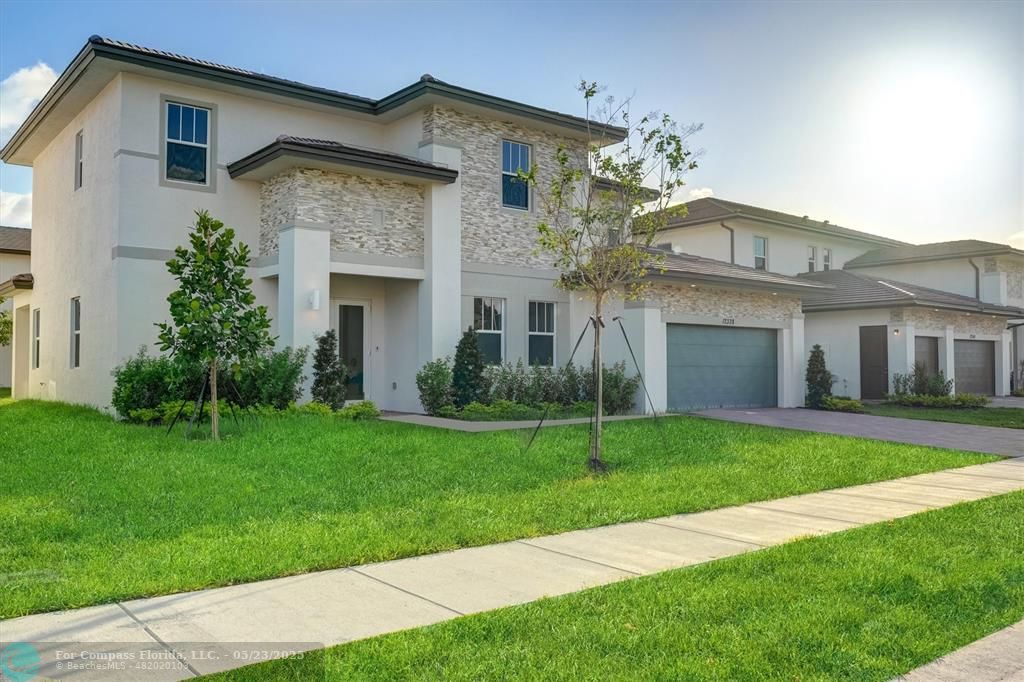 12328 Southwest 43rd Street Davie, FL 33330 - Photo 8 of 96 a front view of a house with a yard