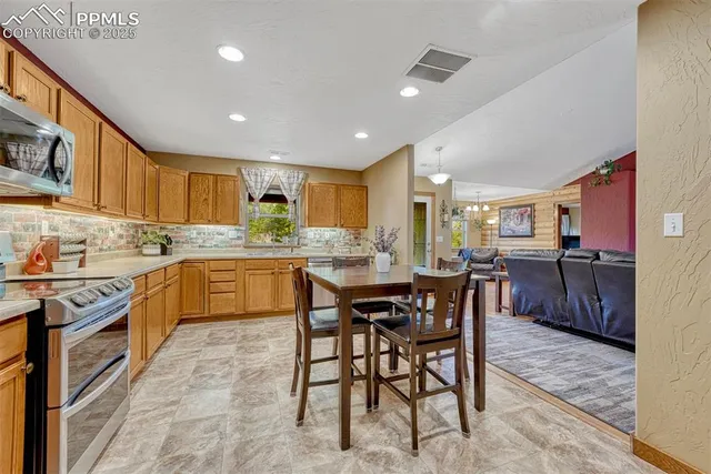 a kitchen with kitchen island granite countertop wooden cabinets a counter top space and stainless steel appliances