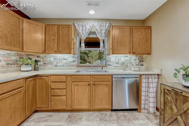 a kitchen with stainless steel appliances granite countertop a sink and cabinets