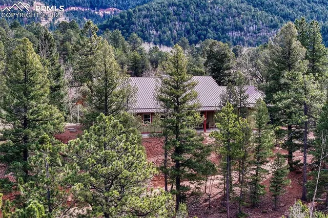 an aerial view of a house with a yard and garden