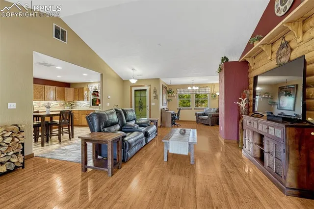 a living room with furniture wooden floor and a flat screen tv