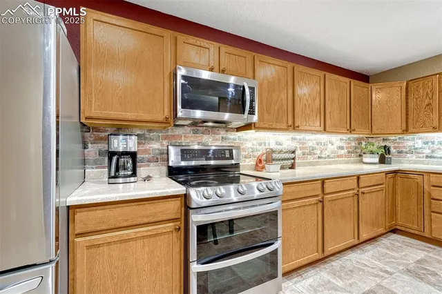 a kitchen with stainless steel appliances a stove a sink and a microwave