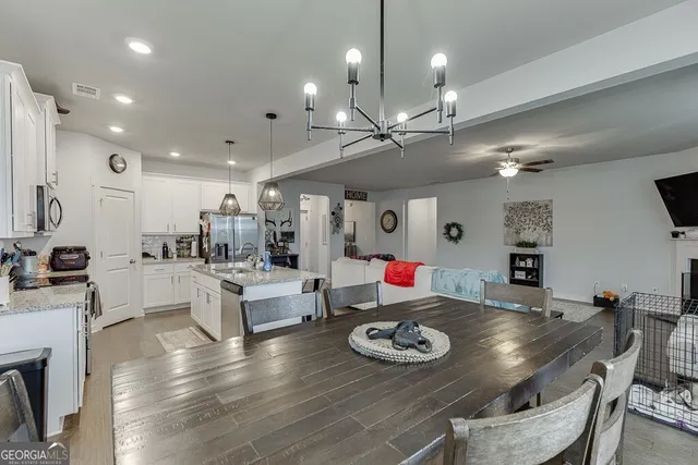 a large kitchen with a table and chairs