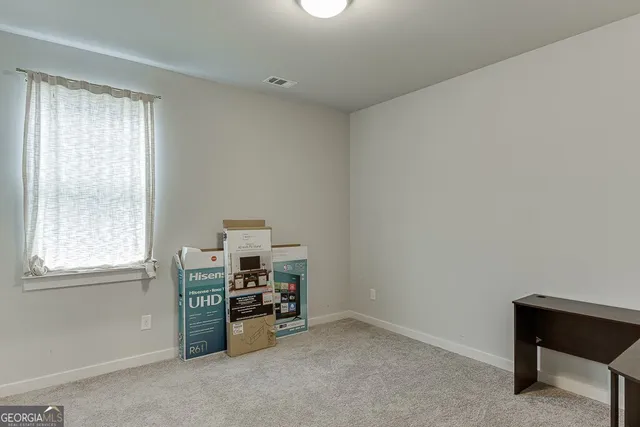 a view of workspace with furniture and window