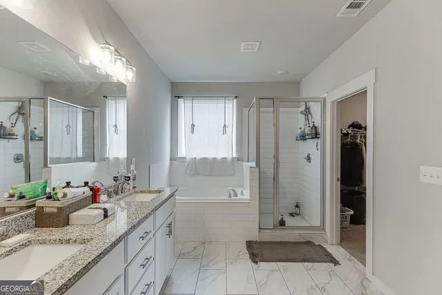 a bathroom with a granite countertop sink a shower and a mirror
