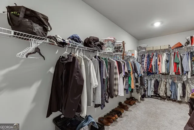 a view of walk in closet with clothes