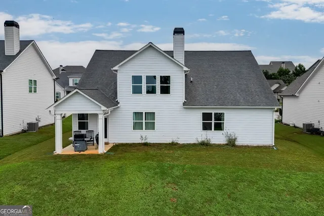a front view of house with yard and green space