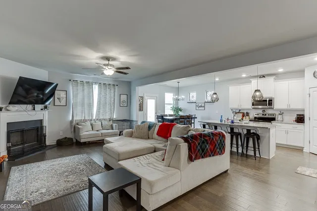 a living room with furniture fireplace and flat screen tv