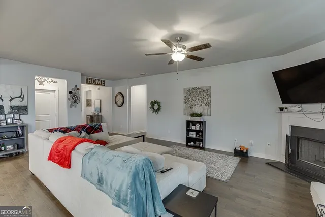 a spacious bedroom with a bed and a flat screen tv