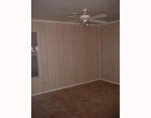 a view of a room with a ceiling fan