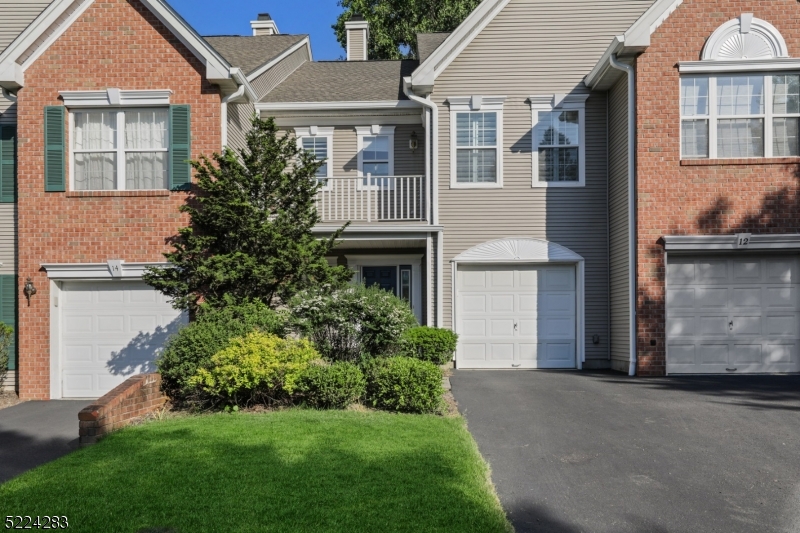 13 Knox Court Bernards, NJ 07920 - Photo 1 of 16 a front view of a house with a garden and plants