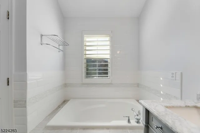a white bath tub sitting next to a window