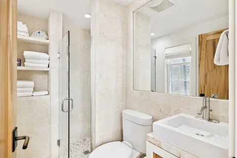 a bathroom with a sink toilet and shower