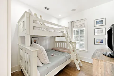 a bedroom with a bed next to a window with the outer view