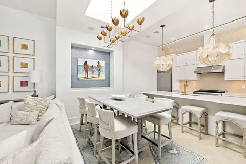 a view of a dining room with furniture a chandelier and wooden floor