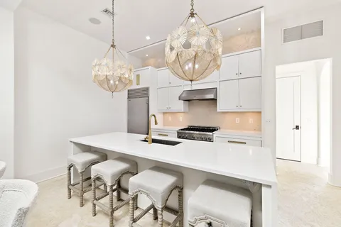 a kitchen with a table chairs and cabinets