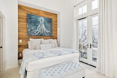 a bedroom with a bed and a painting on the wall