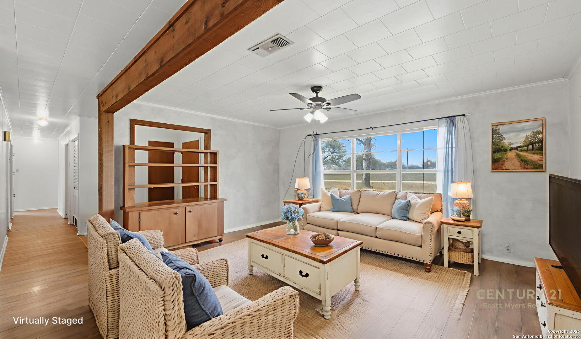 a living room with furniture and a floor to ceiling window