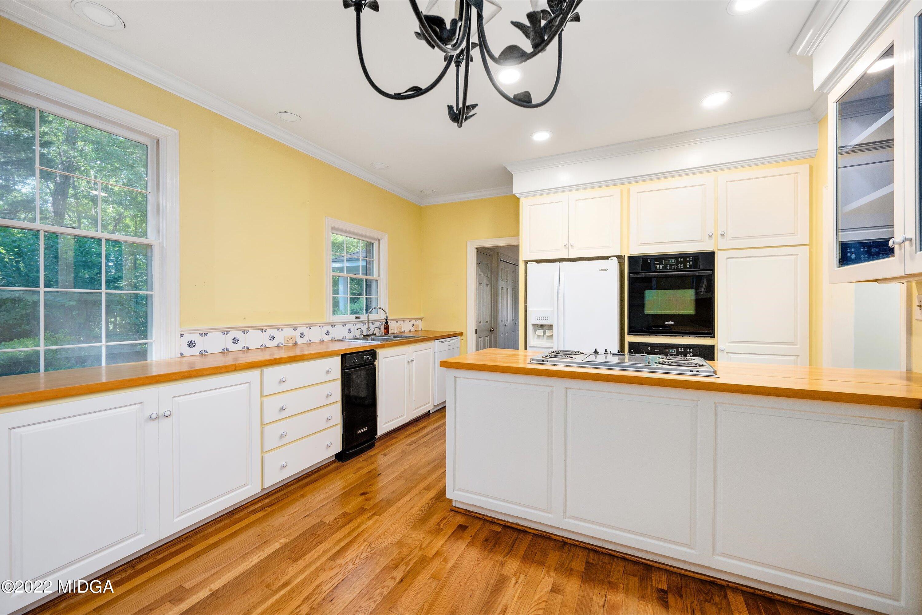 138 Covington Place, Unit 13 Macon, GA 31210 - Photo 11 of 23 a view of a kitchen with kitchen island a large window and stainless steel appliances