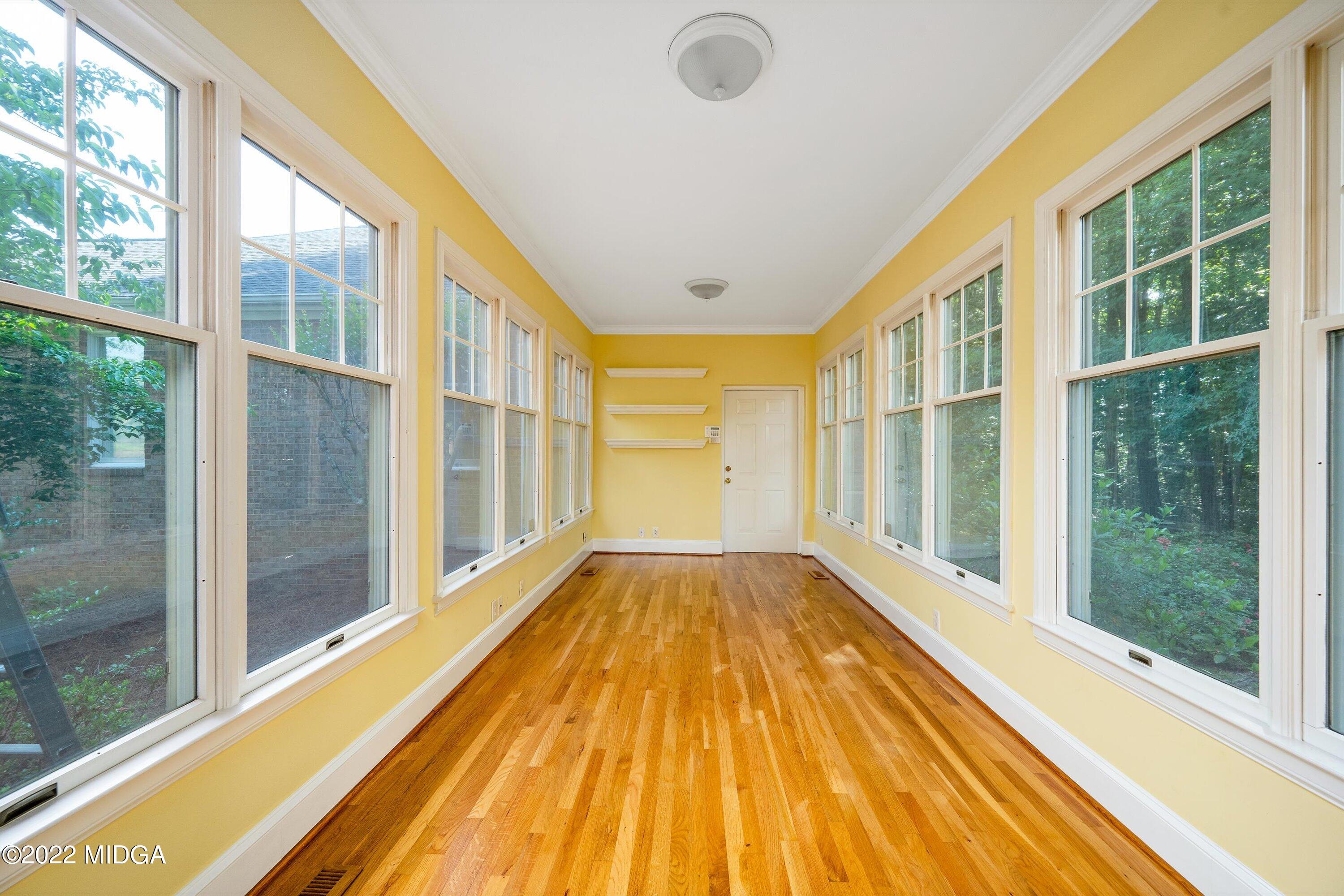 138 Covington Place, Unit 13 Macon, GA 31210 - Photo 13 of 23 a view of an empty room with wooden floor and a window