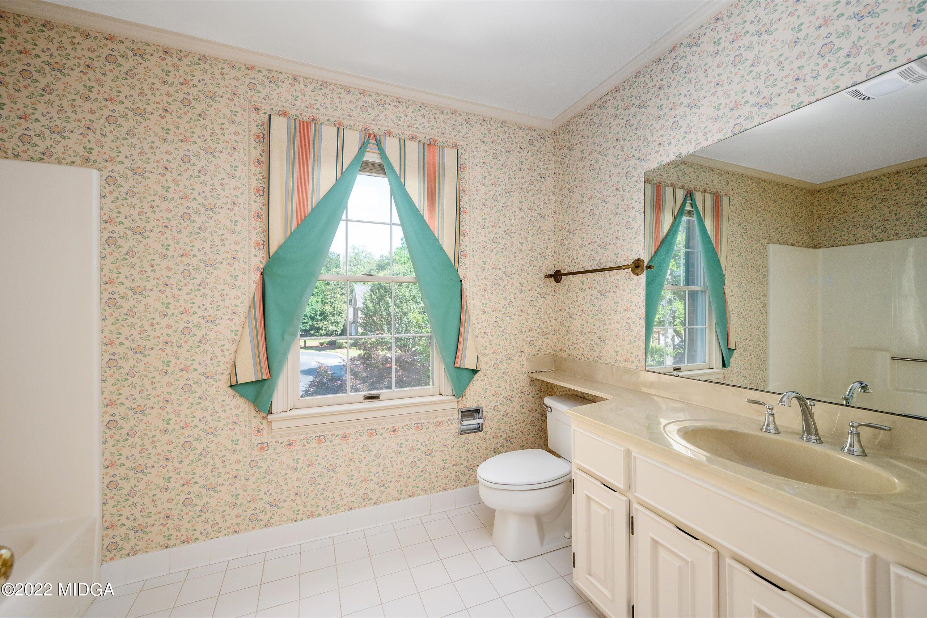 138 Covington Place, Unit 13 Macon, GA 31210 - Photo 17 of 23 a bathroom with a granite countertop sink toilet and mirror