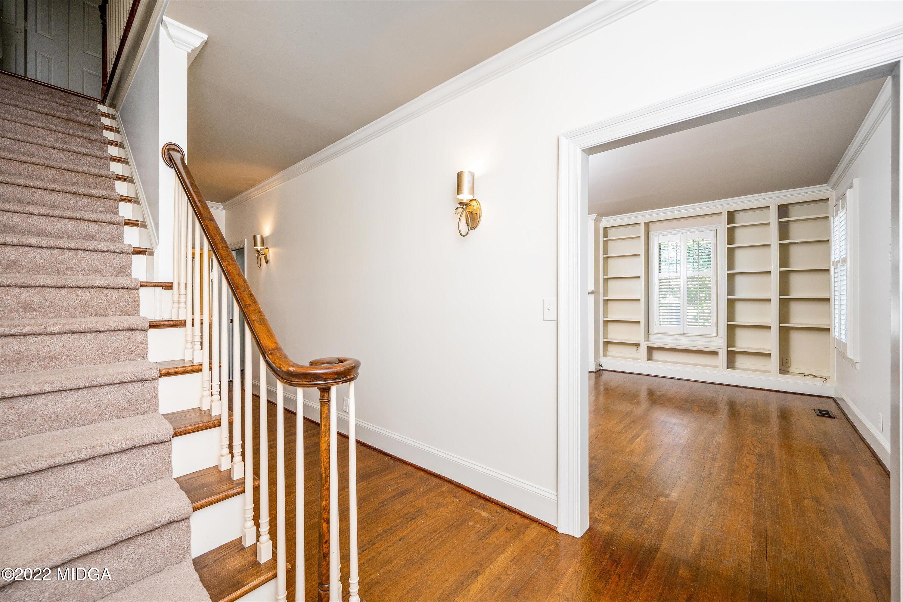 138 Covington Place, Unit 13 Macon, GA 31210 - Photo 3 of 23 a view of a hallway with wooden floor and staircase