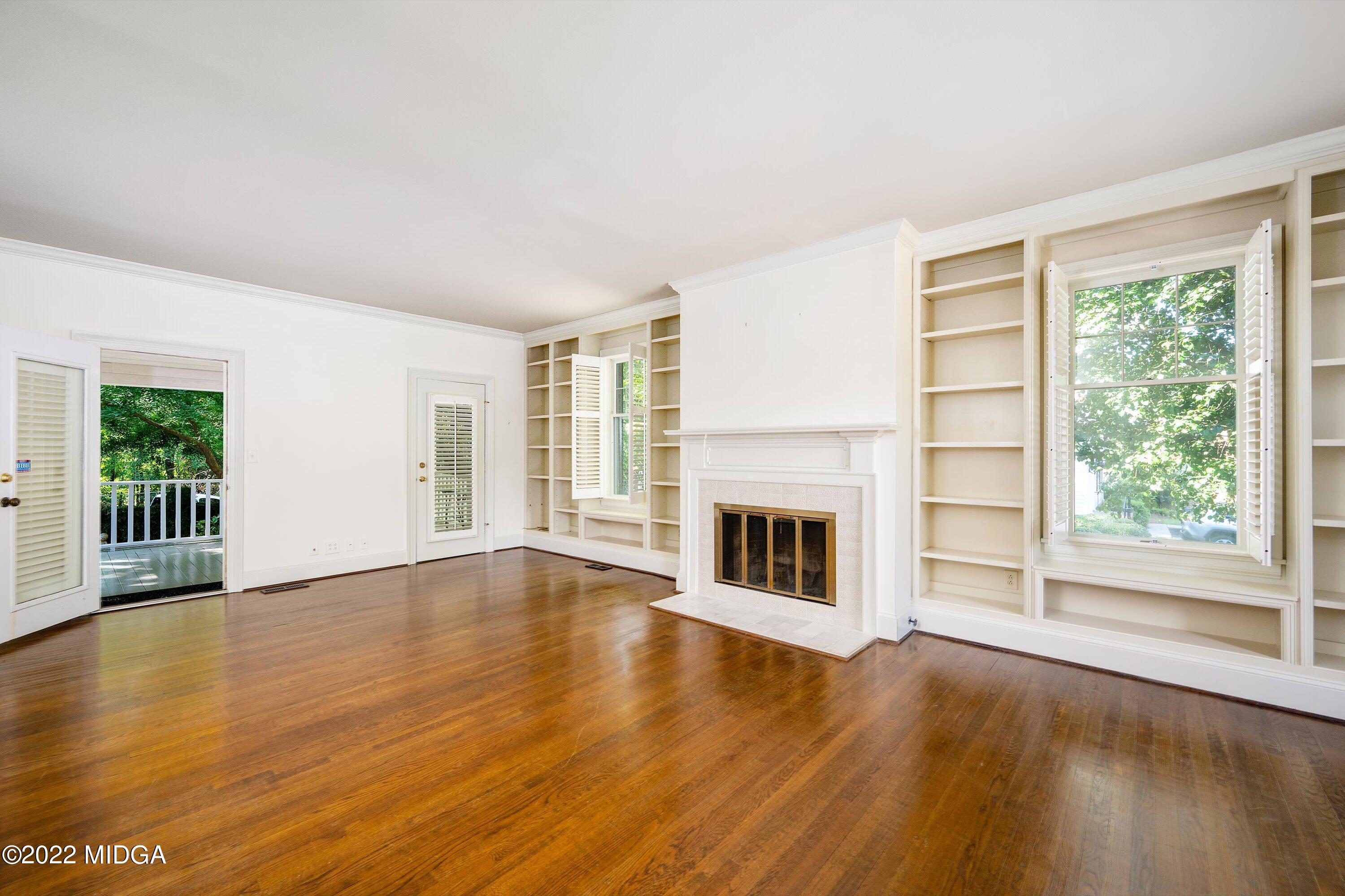 138 Covington Place, Unit 13 Macon, GA 31210 - Photo 4 of 23 a view of empty room with wooden floor and fireplace