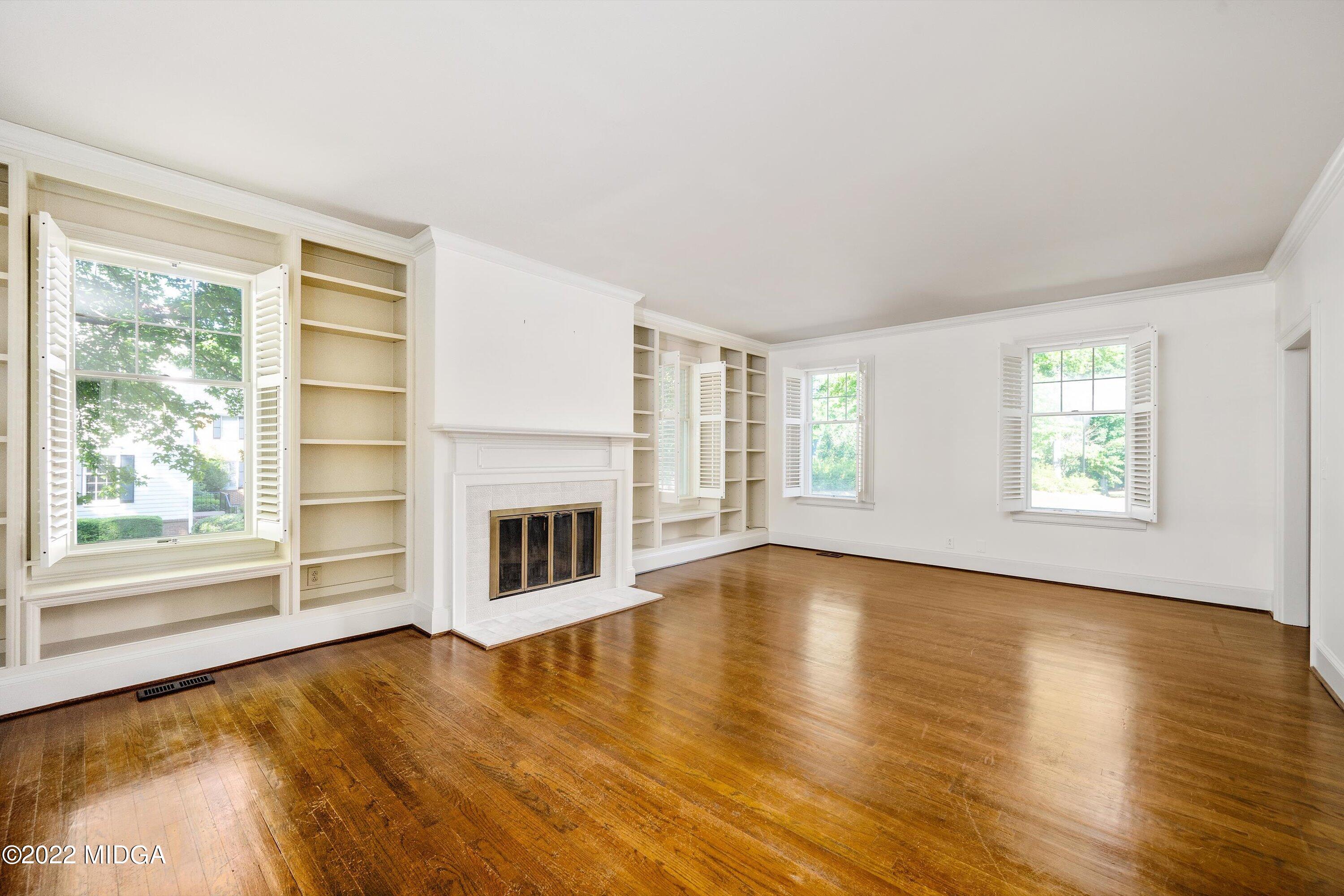 138 Covington Place, Unit 13 Macon, GA 31210 - Photo 5 of 23 a view of a livingroom with a fireplace wooden floor and windows