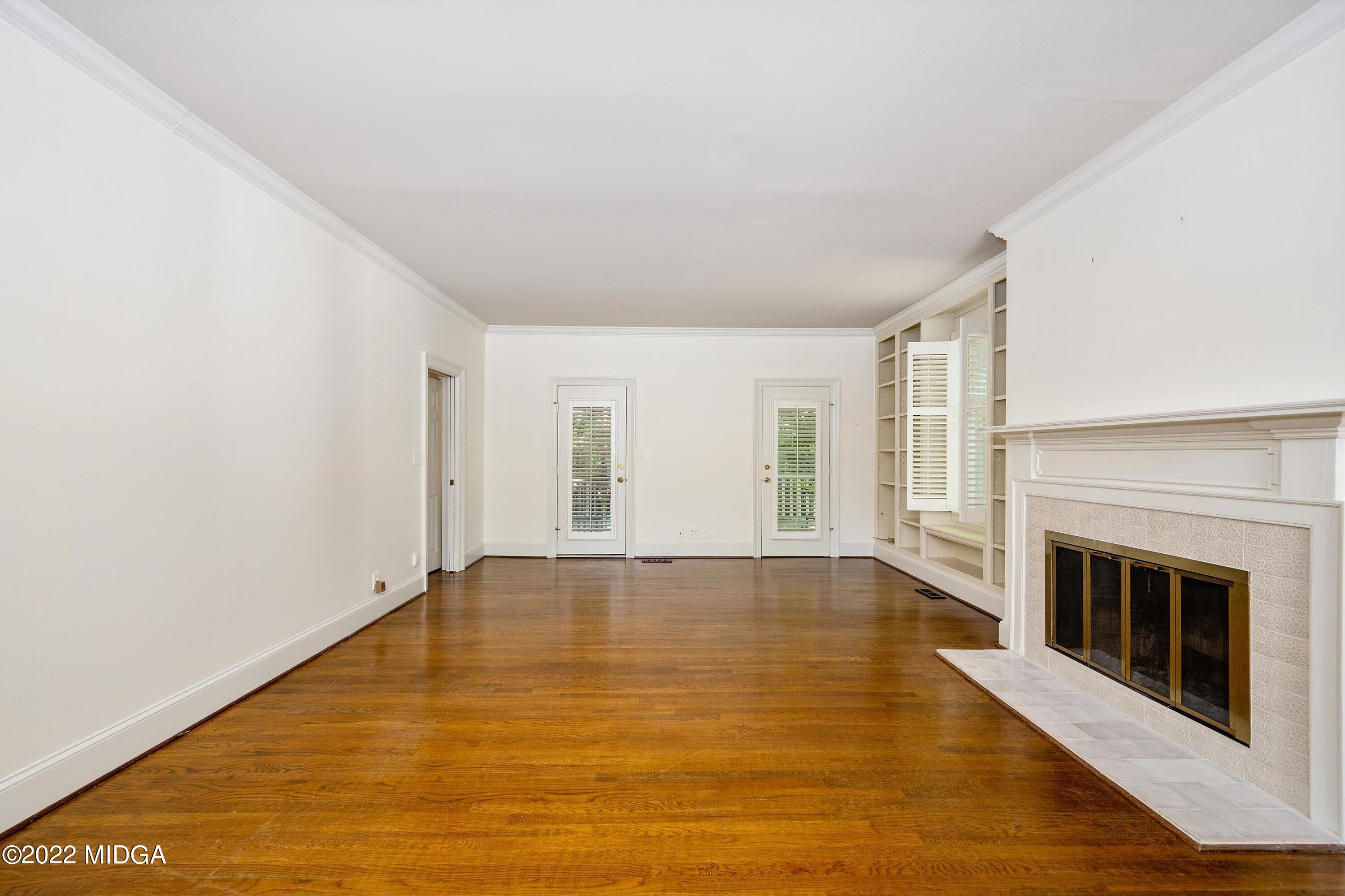 138 Covington Place, Unit 13 Macon, GA 31210 - Photo 6 of 23 a view of empty room with wooden floor and fireplace