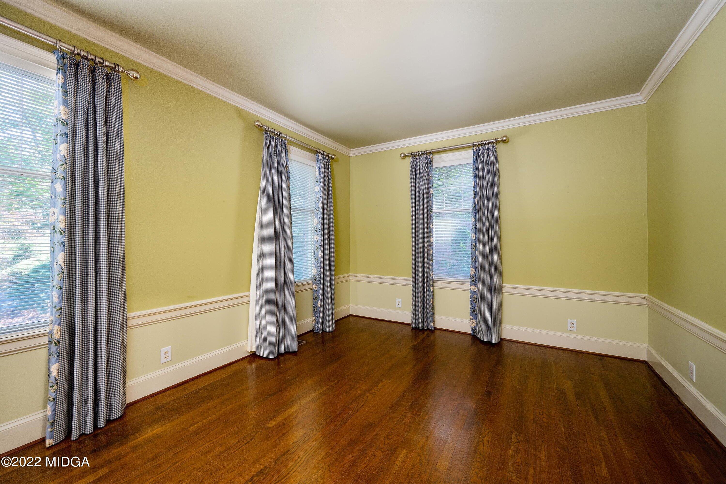 138 Covington Place, Unit 13 Macon, GA 31210 - Photo 7 of 23 an empty room with wooden floor and door