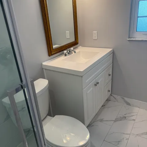 a bathroom with a toilet and a shower