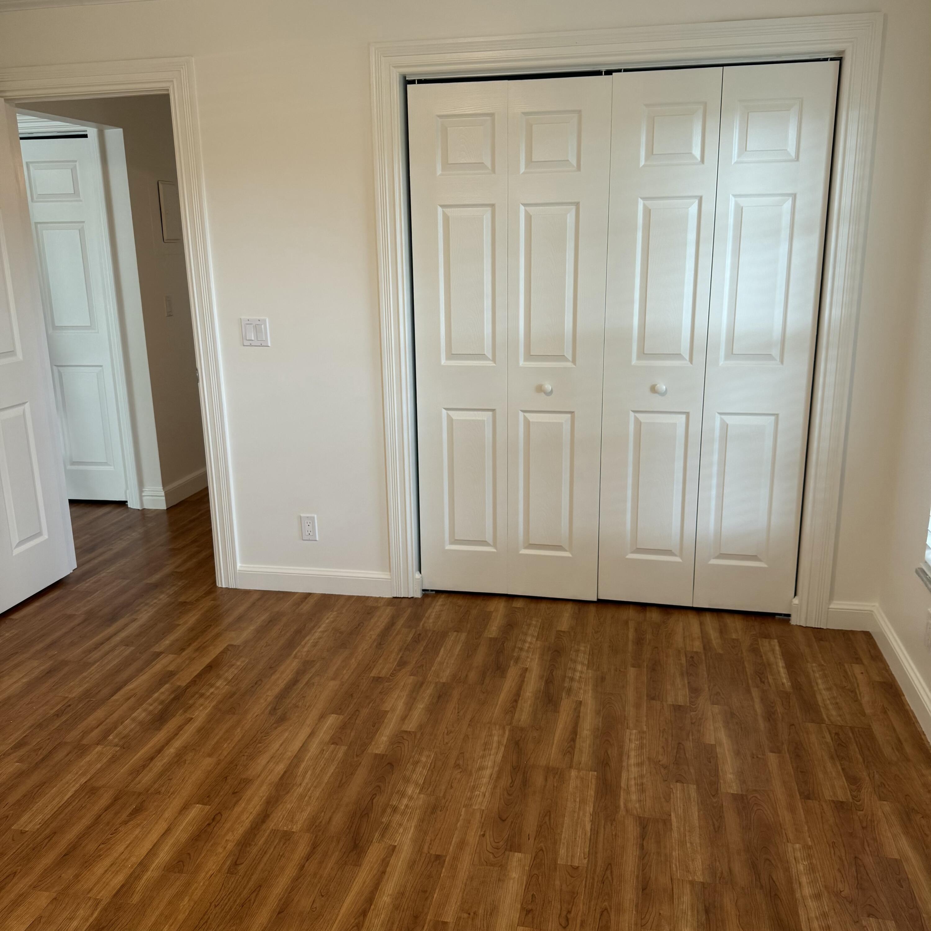 431 Jupiter Lakes Boulevard, Unit 2112A Jupiter, FL 33458 - Photo 15 of 19 a view of an empty room with wooden floor