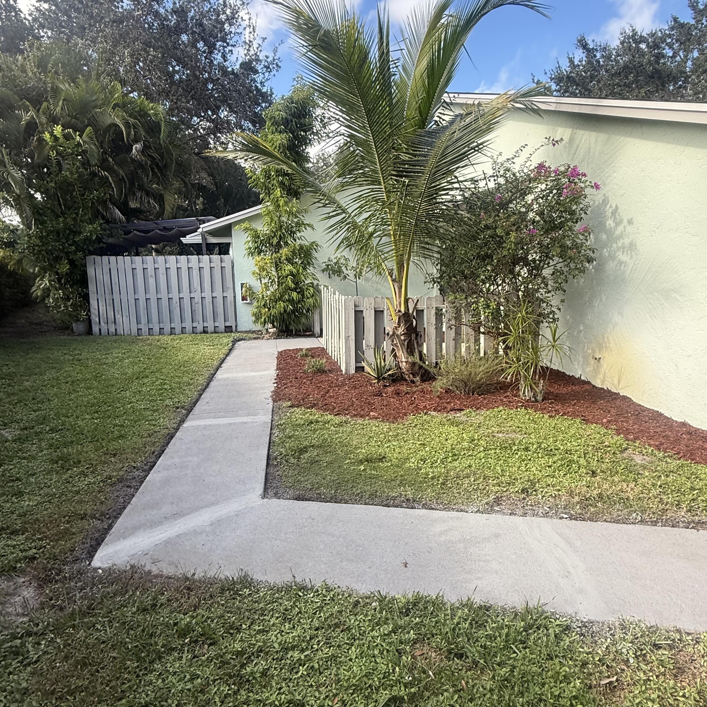 431 Jupiter Lakes Boulevard, Unit 2112A Jupiter, FL 33458 - Photo 18 of 19 a front view of a house with garden