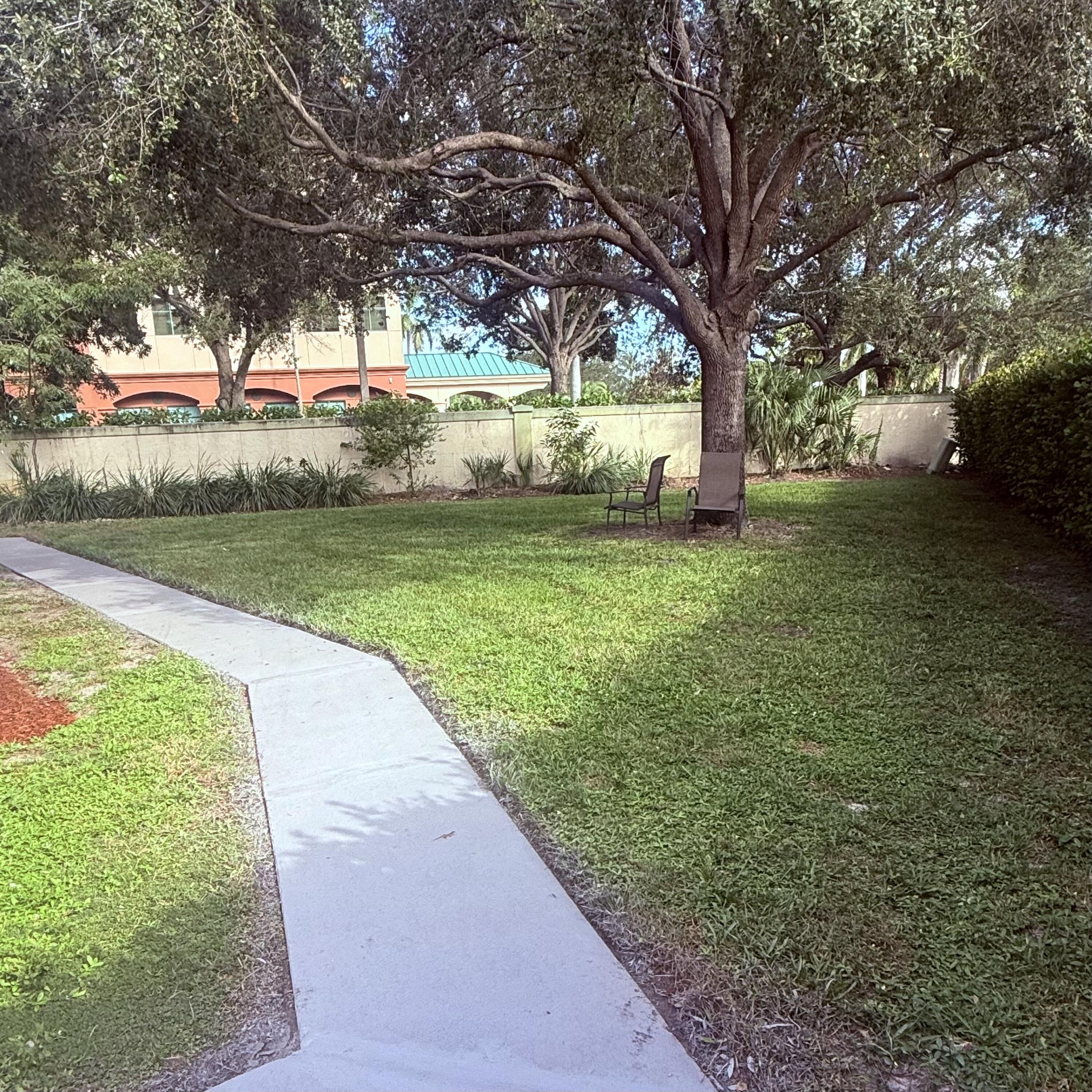 431 Jupiter Lakes Boulevard, Unit 2112A Jupiter, FL 33458 - Photo 19 of 19 a view of a yard with an trees