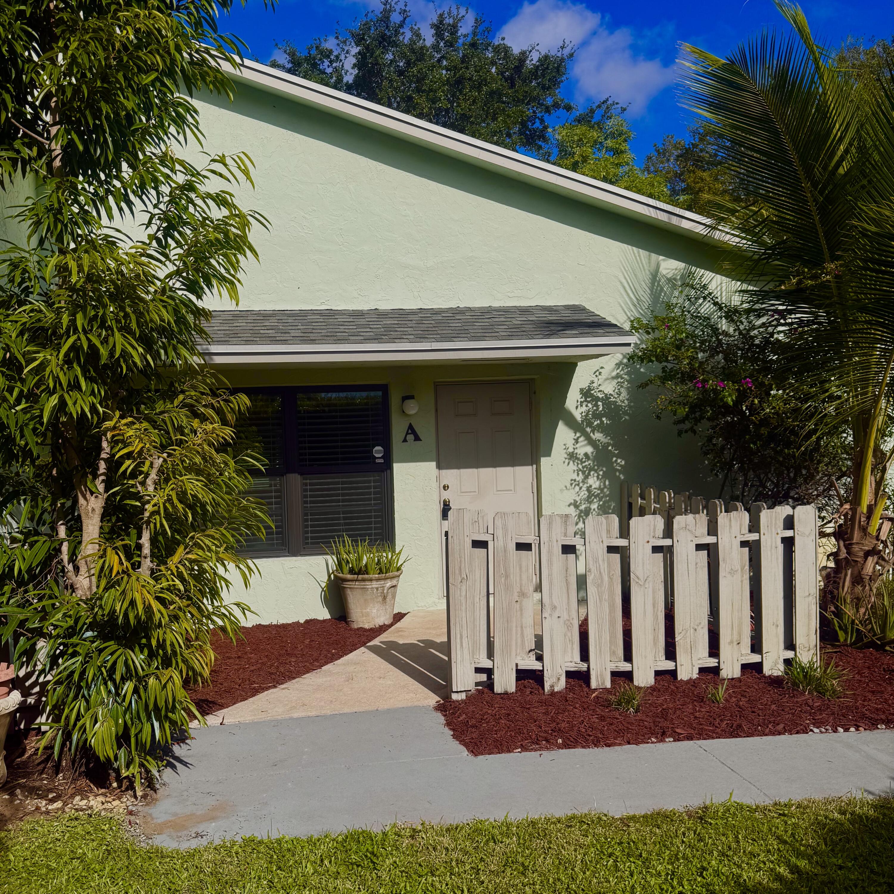 431 Jupiter Lakes Boulevard, Unit 2112A Jupiter, FL 33458 - Photo 2 of 19 a front view of a house with a yard