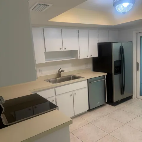 a kitchen with cabinets and appliances