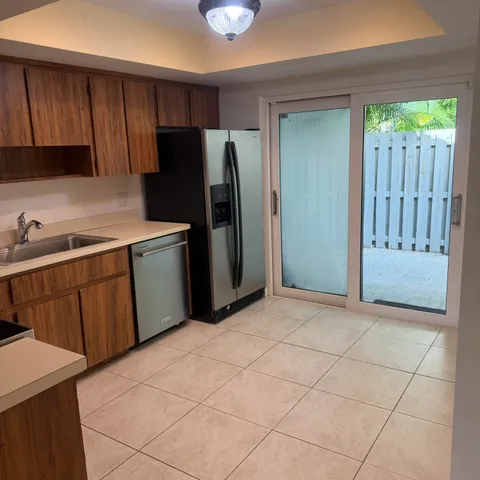 a kitchen with stainless steel appliances granite countertop a refrigerator and a sink
