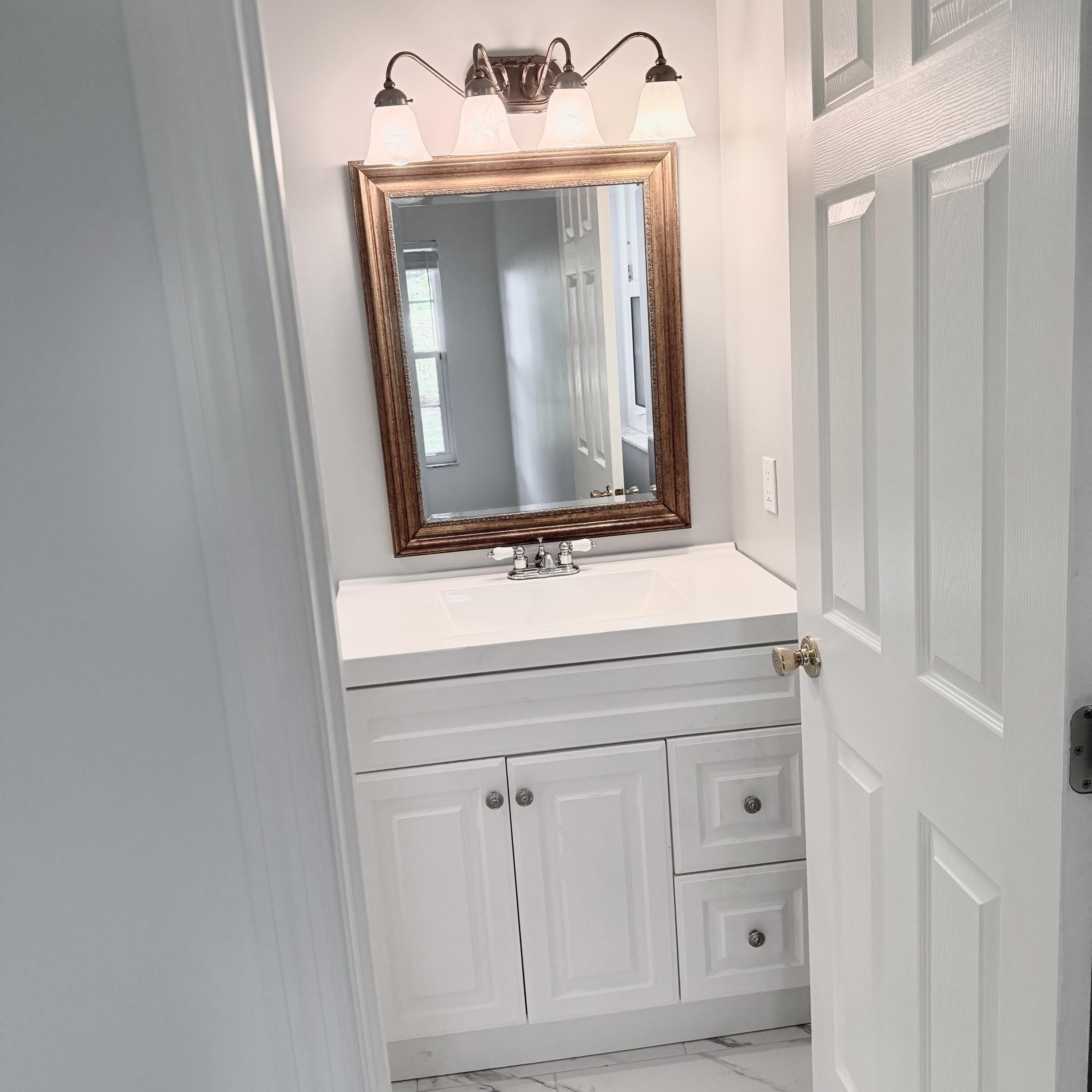 431 Jupiter Lakes Boulevard, Unit 2112A Jupiter, FL 33458 - Photo 10 of 19 a bathroom with a sink and a mirror