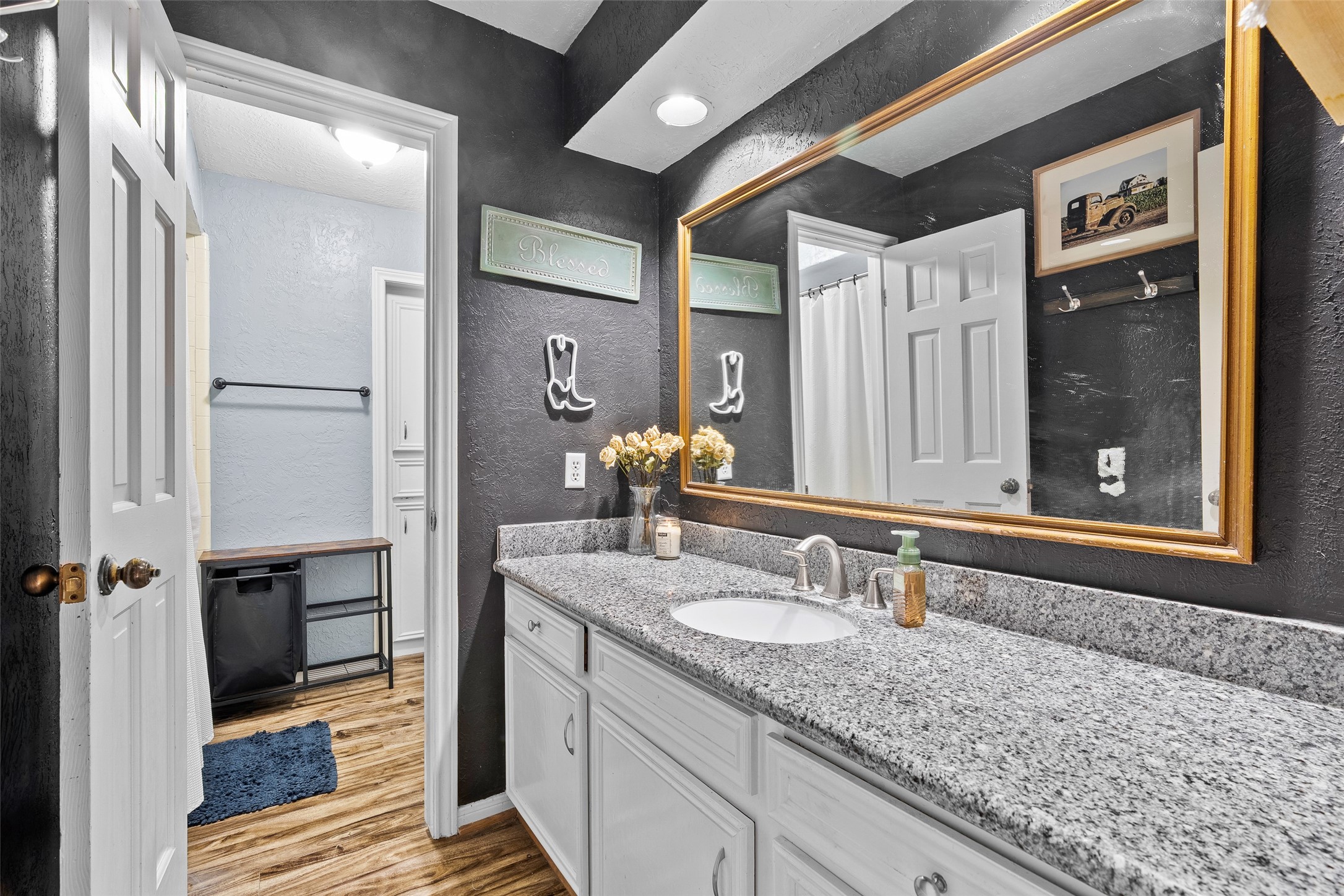 41 Windsor Drive Conroe, TX 77304 - Photo 26 of 39 Upstairs full bathroom featuring a single vanity with a granite countertop, framed mirror, and a tub/shower combination.