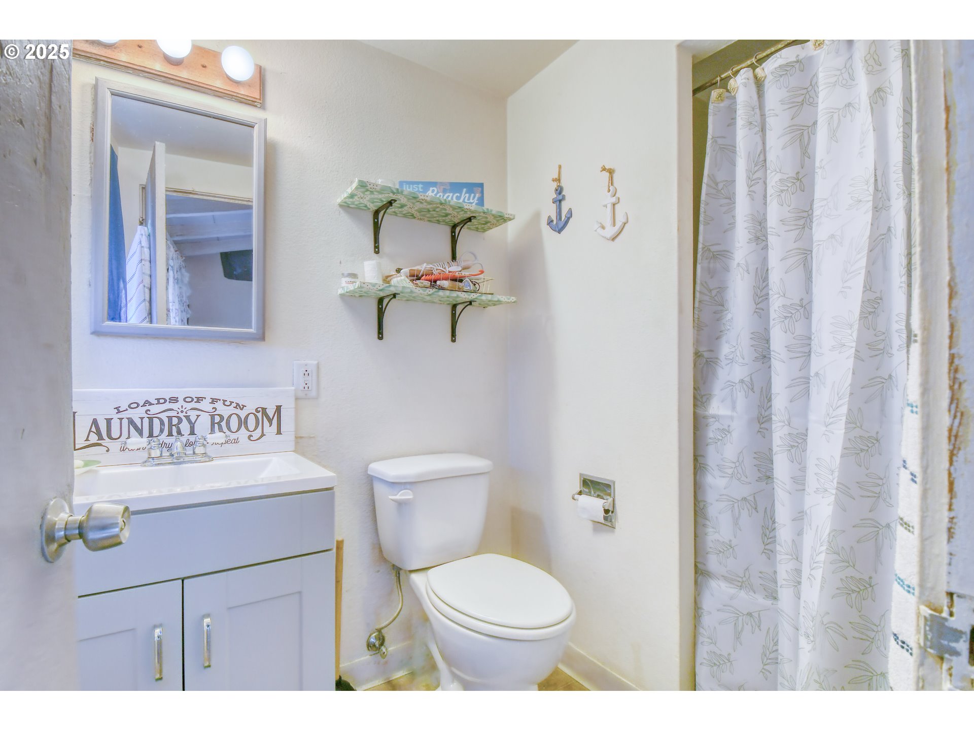 2805 Southwest Marshall Avenue Pendleton, OR 97801 - Photo 24 of 36 a bathroom with a toilet sink vanity and mirror