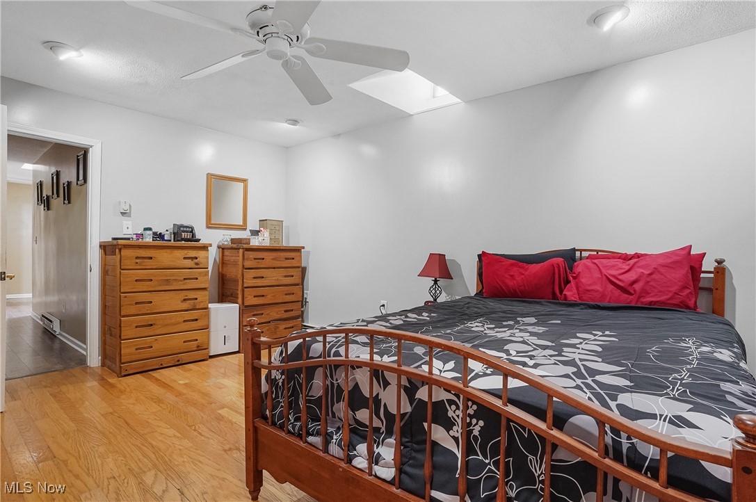 35977 Teegarden Road Salem, OH 44460 - Photo 19 of 50 Bedroom with wood finished floors, a skylight, and a ceiling fan