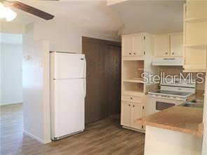 4102 Darlington Road Holiday, FL 34691 - Photo 6 of 9 a kitchen with a refrigerator sink stove and cabinets