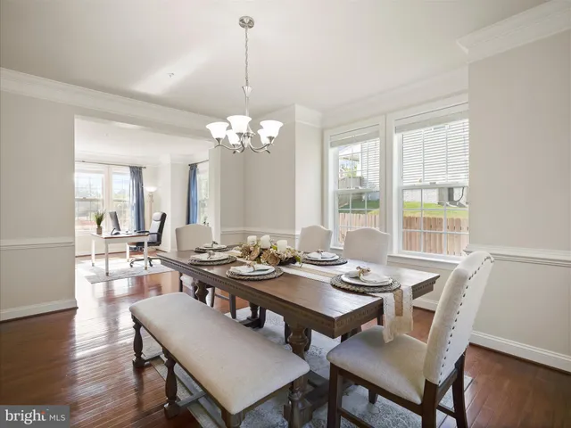 a view of a dining room with furniture wooden floor and chandelier