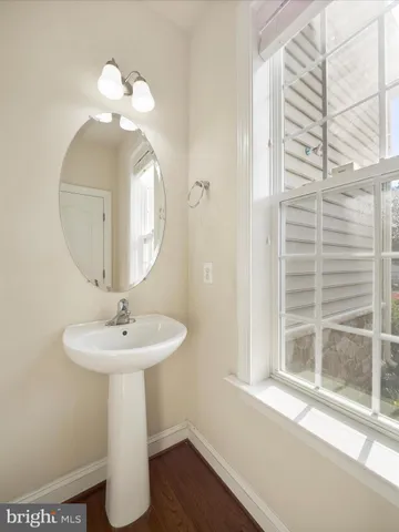 a bathroom with a sink a mirror and a window