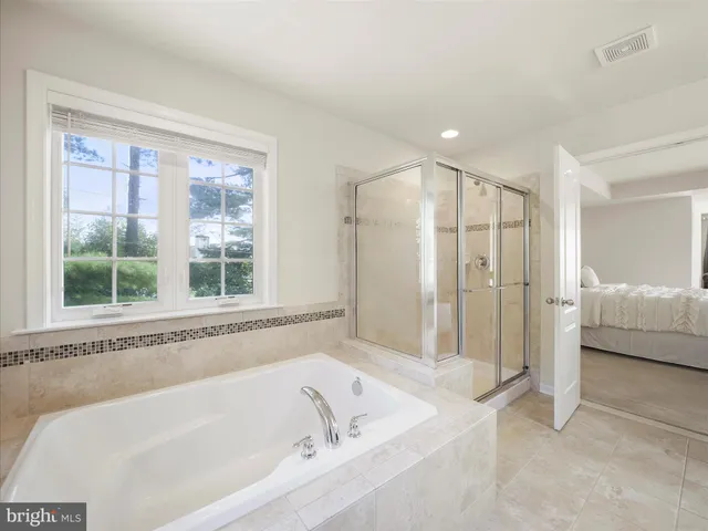 a bathroom with a bathtub and a shower