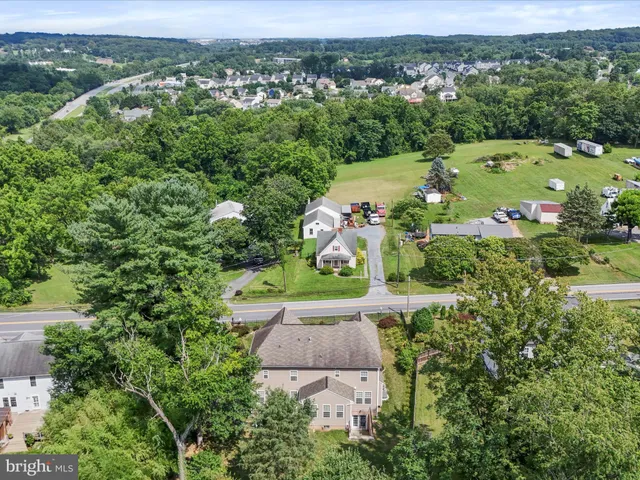 an aerial view of a house with a yard