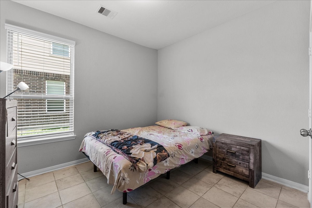 2320 Rosemary Street Rosenberg, TX 77469 - Photo 26 of 40 This cozy bedroom #3 features tile flooring, a single window providing natural light. This room is perfect for a guest room or small personal space.