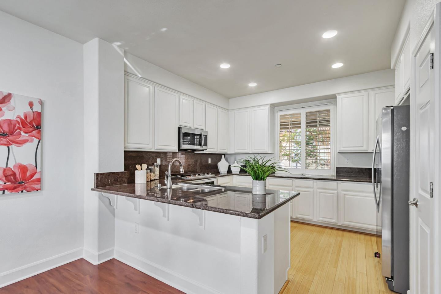 1142 Mente Linda Loop Milpitas, CA 95035 - Photo 7 of 36 a kitchen with granite countertop a sink stove and refrigerator