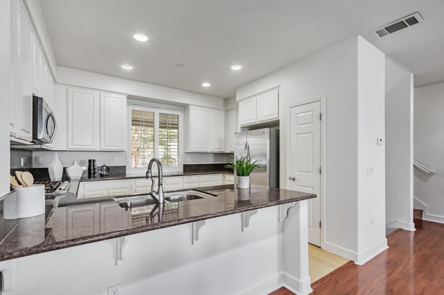 1142 Mente Linda Loop Milpitas, CA 95035 - Photo 8 of 36 a kitchen with granite countertop a sink a counter top space and stainless steel appliances